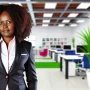 DALL·E 2024-07-11 08.51.52 - A professional African woman in her 30s with curly hair, wearing a smart business suit, standing confidently in a modern office setting. The backgroun